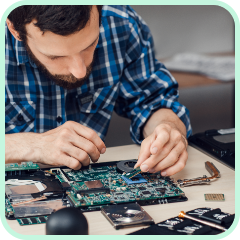 Man working on a used chromebook for sale and providing a computer cleaning service