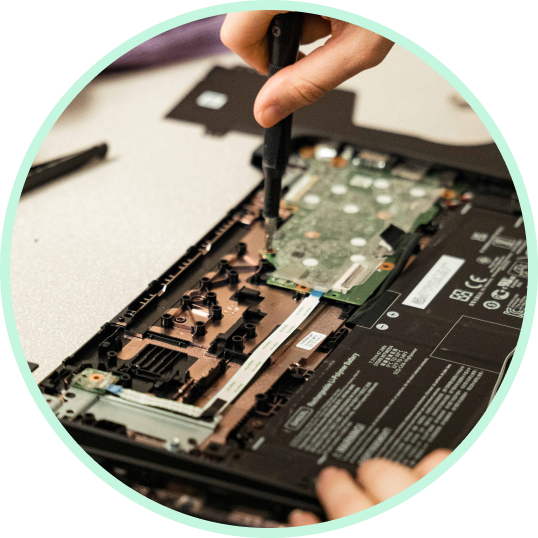 A technician repairing an Acer Chromebook motherboard.
